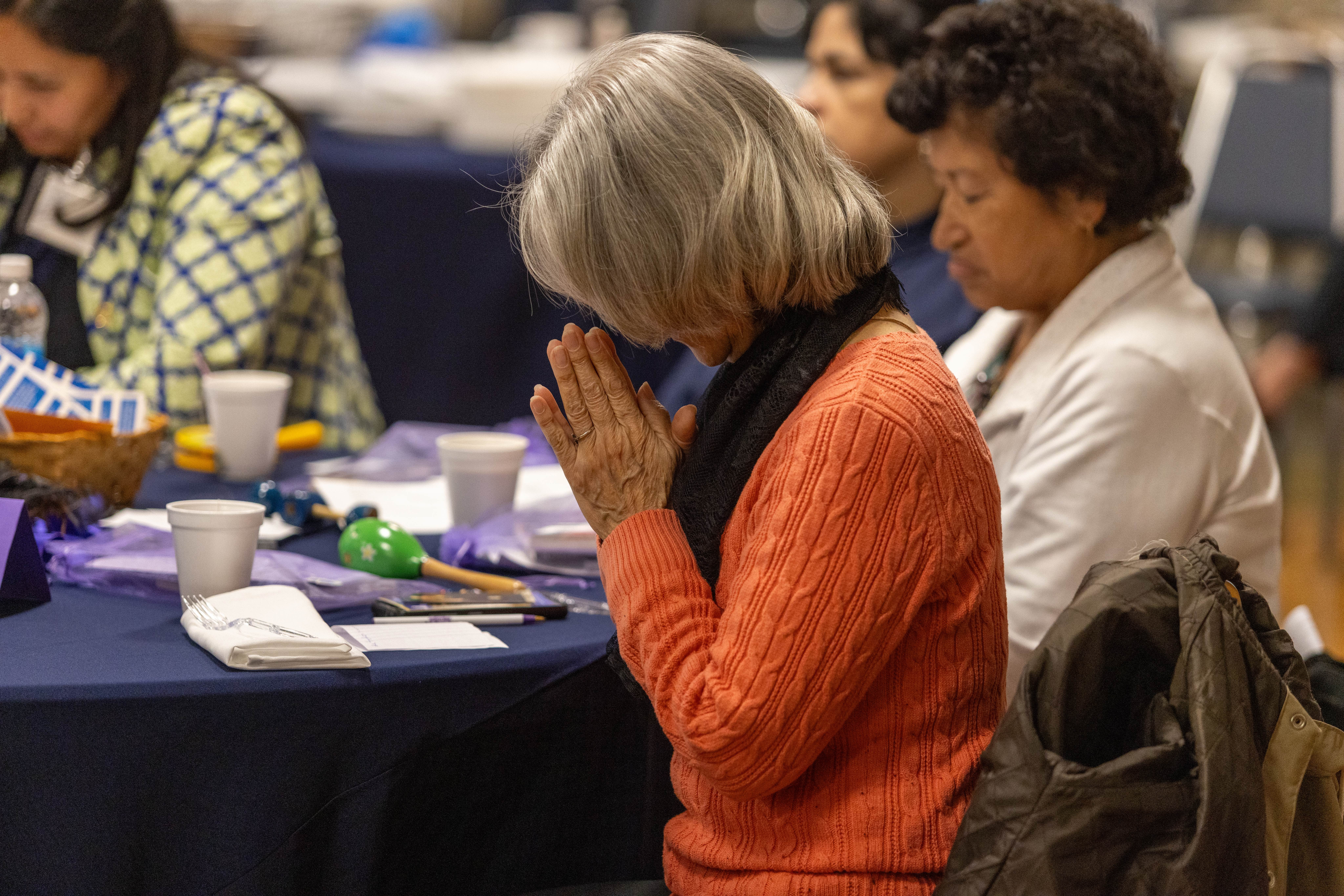 Women pray at the 35th anniversary breakfast for the St. Petersburg chapter of Magnificat.