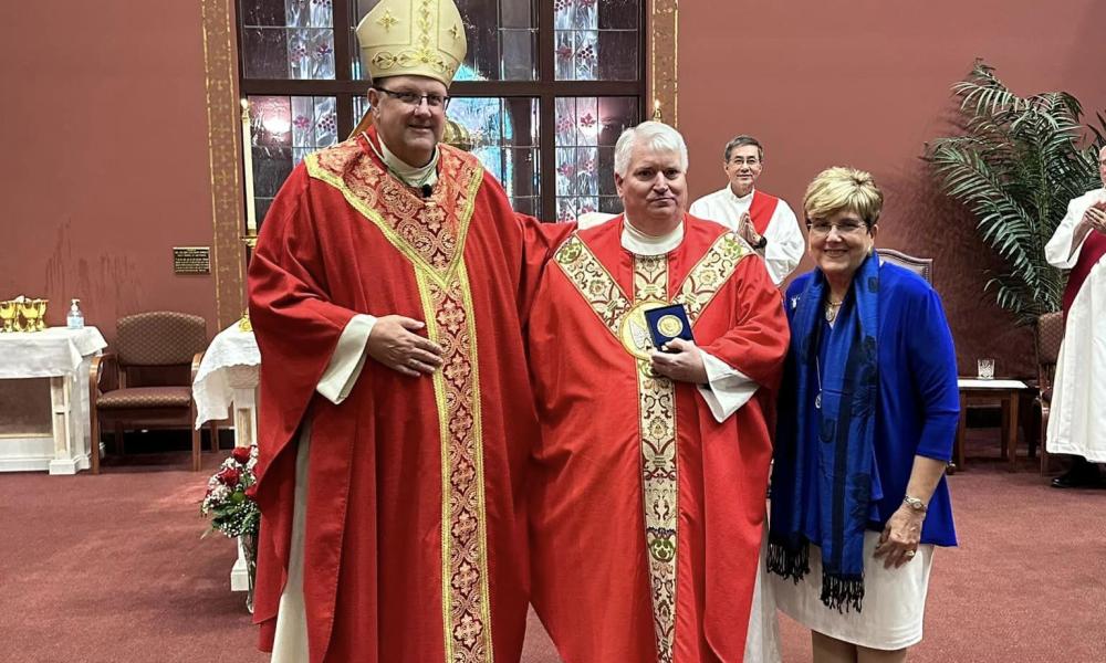 Father Waters receiving the John Paul II Award