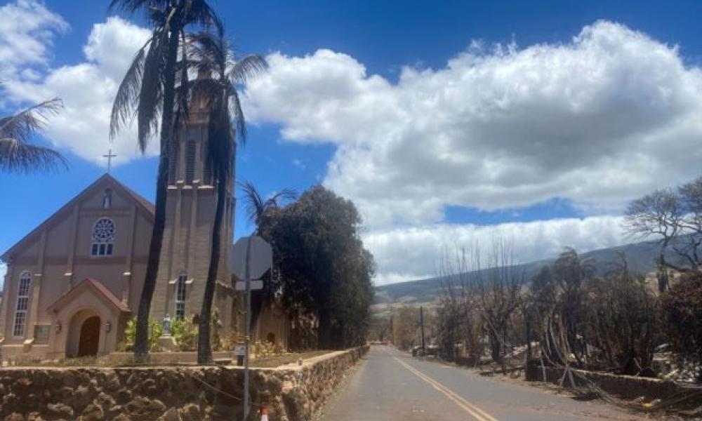 Burned houses are seen adjacent of Maria Lanakila Catholic Church on Aug. 11, 2023, in the aftermath of a wildfire in Lahaina, western Maui, Hawaii.