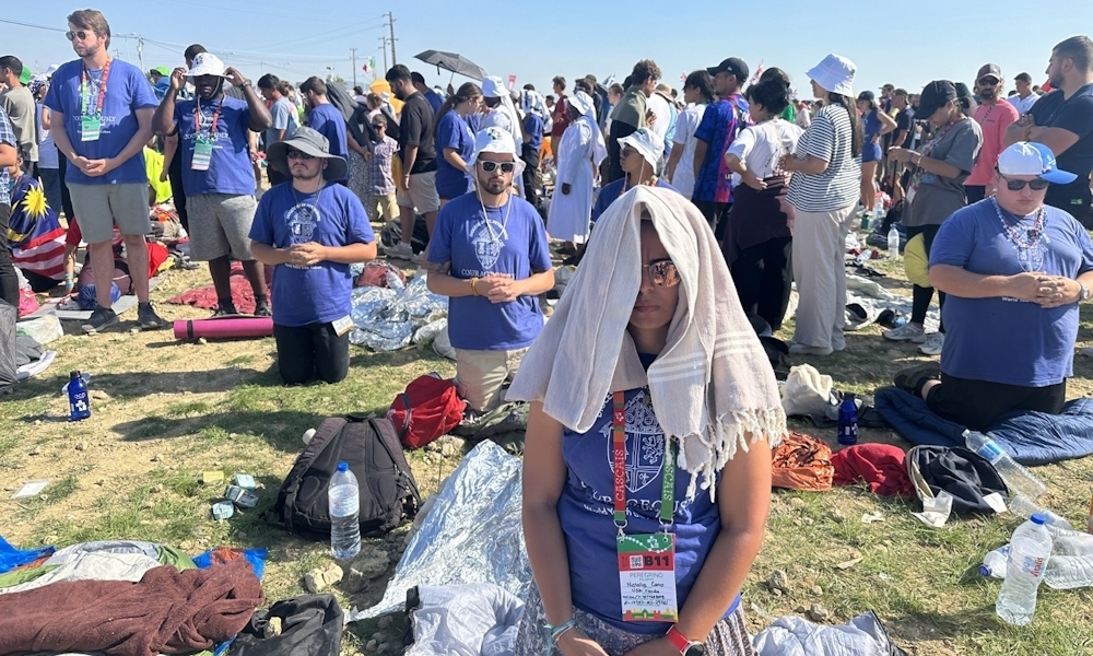 Natalia Cano, feligrés de Nativity junto con otros feligreses de la Diócesis de St. Petersburg de rodillas durante la Misa de clausura con el papa Francisco en el parque Tejo en Lisboa, Portugal el 6 de agosto de 2023. Fotografía por Keishla Espinal.