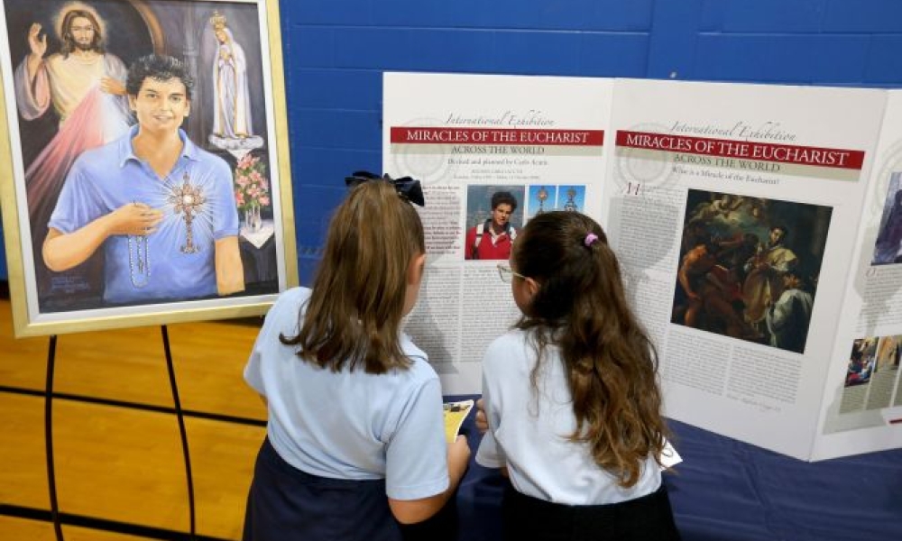 School children read about the life of Blessed Carlo Acutis at the celebration of his new shrine at St. Dominic Parish in Brick, New Jersey. Photo by Thomas P. Costello II