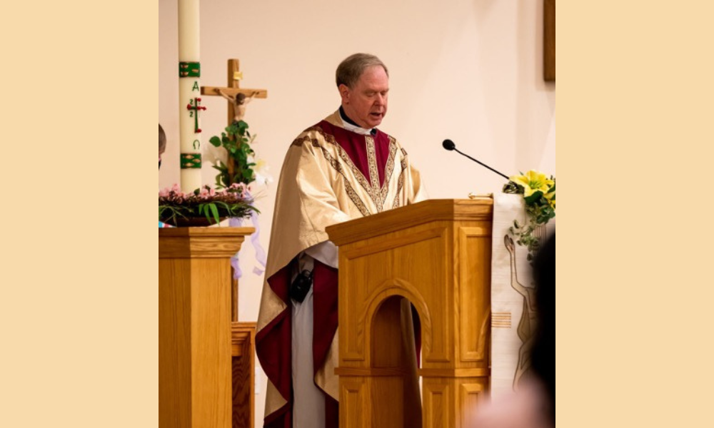 Father Johnson giving a homily