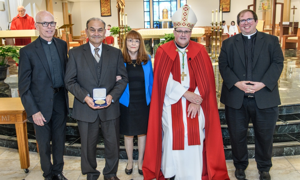 From left to right; Msgr. Robert Gibbons, Pastor of St. Paul Catholic Church in St. Petersburg, Joe and Rose-Mary Grasso, St. Jude Medal Award recipients for St. Paul Catholic Church in St. Petersburg, Bishop Gregory Parkes, Bishop of the Diocese of St. Petersburg, and Fr. Tim Williford, Parochial Vicar at St. Paul Catholic Church in St. Petersburg at the 2023 St. Jude Medals Presentation on October 29, 2023. Photo by Ray Bassett