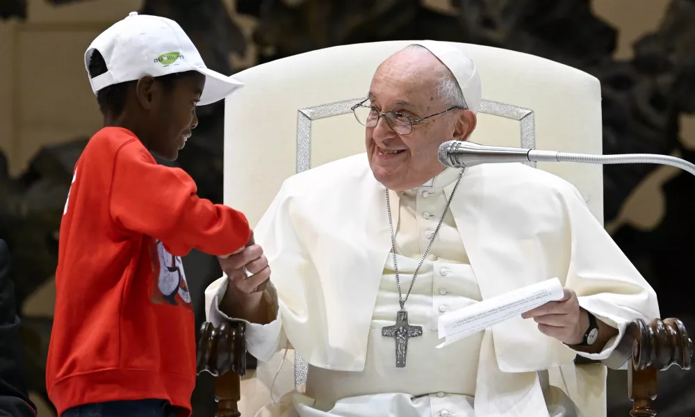 Pope Francis shakes hands with one of the approximately 7,000 children from around the world in the Vatican’s Paul VI Hall on Nov. 6, 2023, at an event sponsored by the Dicastery for Culture and Education dedicated to the theme “Let us learn from boys and girls.” Credit: Vatican Media