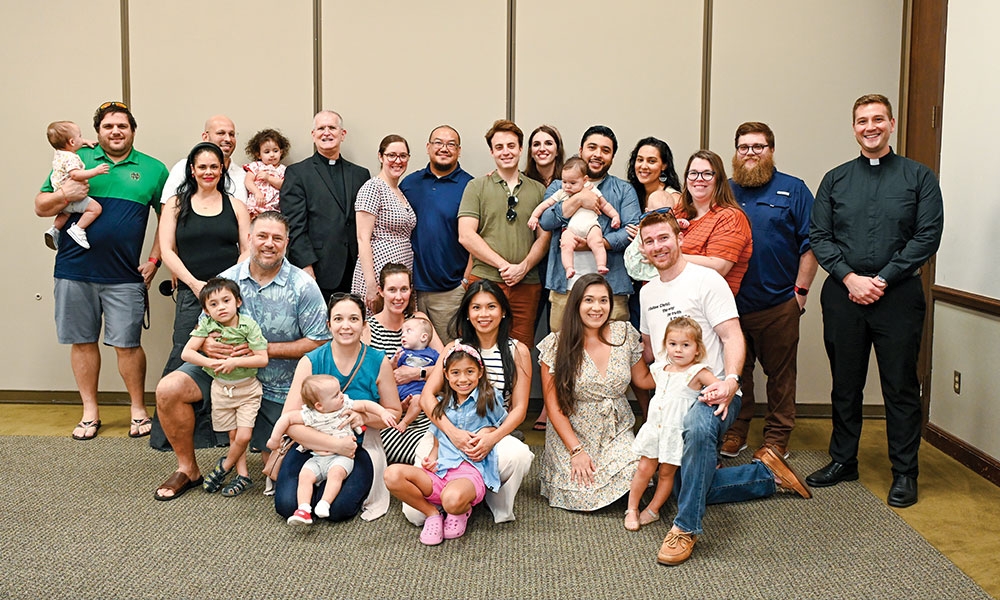 Young families gather for a group photo at the Cathedral of St. Jude the Apostle at a monthly gathering.