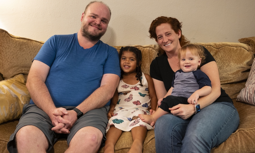 Dr. Stephen Okey, Paige Cargioli, and their children Dorothy and Frank sit on the couch together for a photo. Courtesy Photo.
