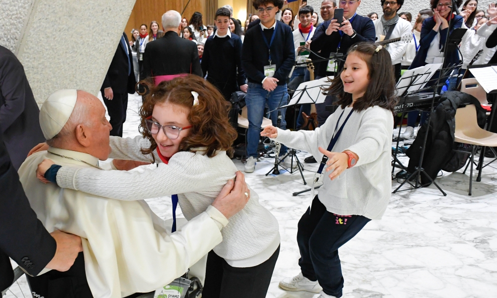 A couple of children rush to hug Pope Francis during a meeting with more than 7,000 people -- including 4,000 youngsters preparing for confirmation -- from the Italian Archdiocese of Bari-Bitonto in the Paul VI Audience Hall at the Vatican. | Photo by CNS/Vatican Media.