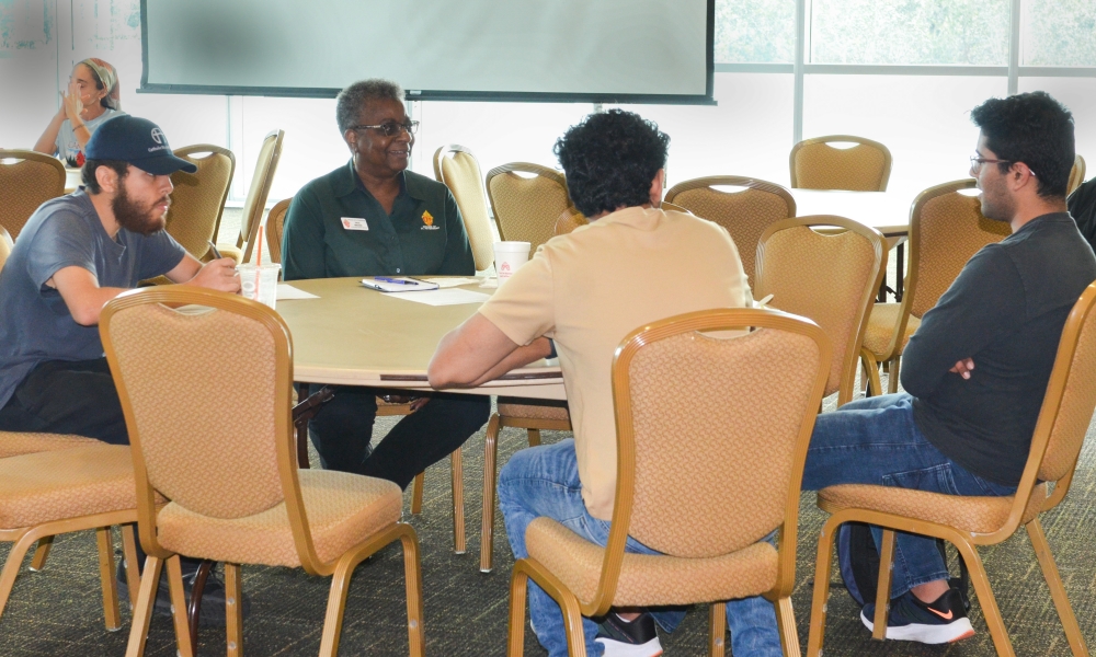 Dale Brown, of the Diocese of St. Petersburg, facilitates a table discussion during a Synod listening session at the University of South Florida in 2022.