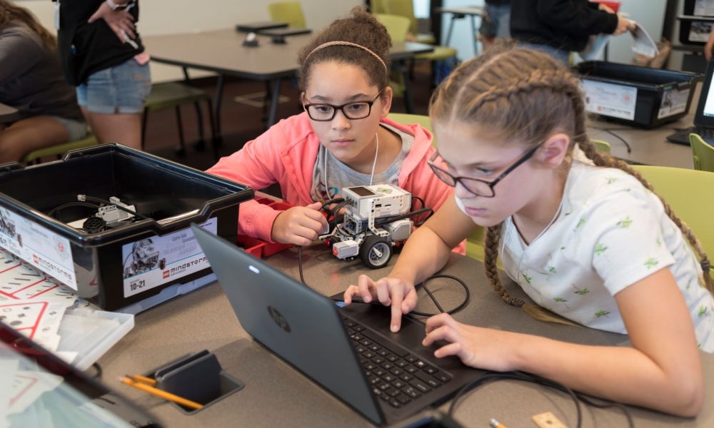 Two Girls Can! Robotic Summer Camp participants engage in intense work with their robot