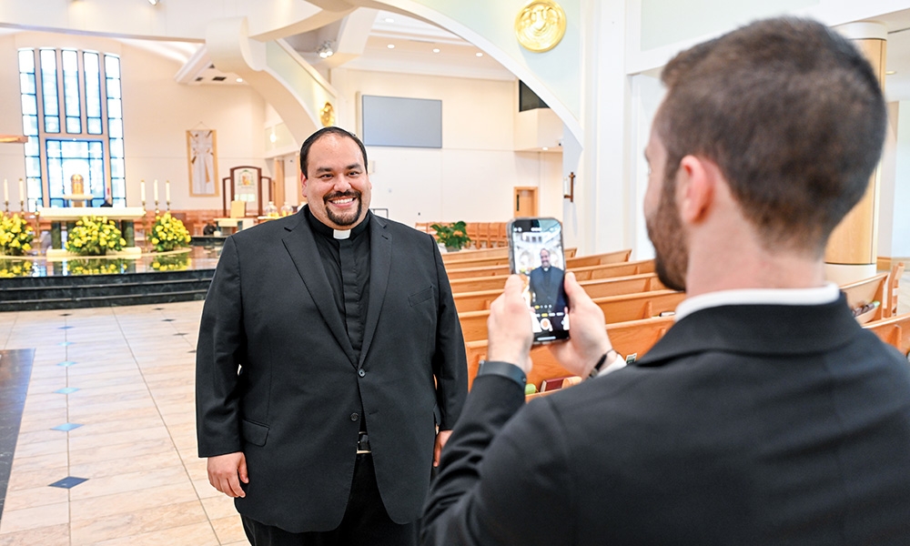 Seminarian Mark DeSio records Father Christian Galvan for social media. 