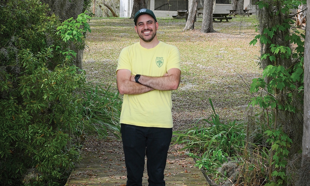 Stephen Watkins, Director of Our Lady of Good Counsel Camp, takes in the serene beauty of the camp's lake, 