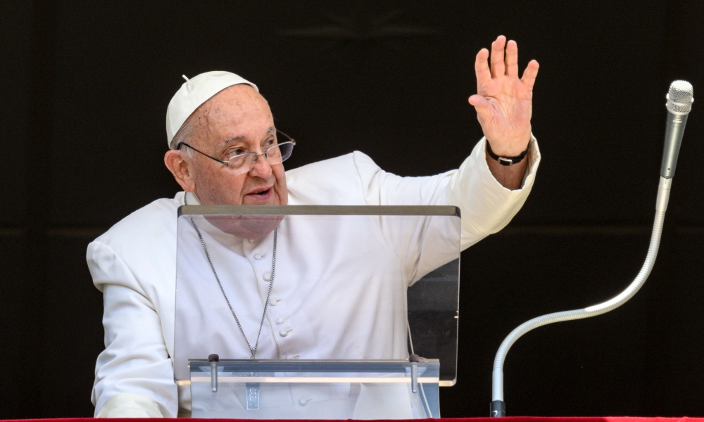 Pope Francis waves to visitors in St. Peter’s Square gathered to pray the Angelus at the Vatican July 14, 2024. (CNS photo/Vatican Media)