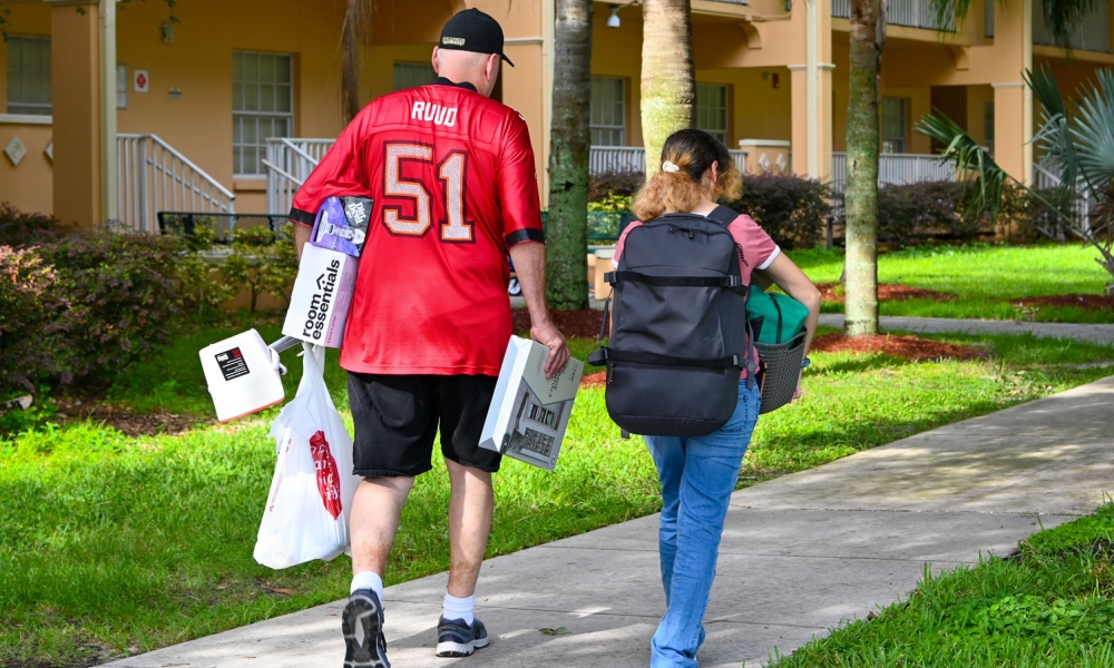 A dad helps his daughter move into her residence hall at a past Saint Leo University move-in day.