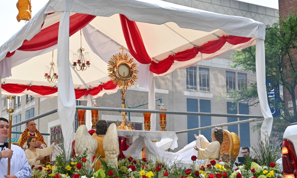 The Blessed Sacrament processes through an intersection in downtown Indianapolis during the National Eucharistic Congress on July 20, 2024.