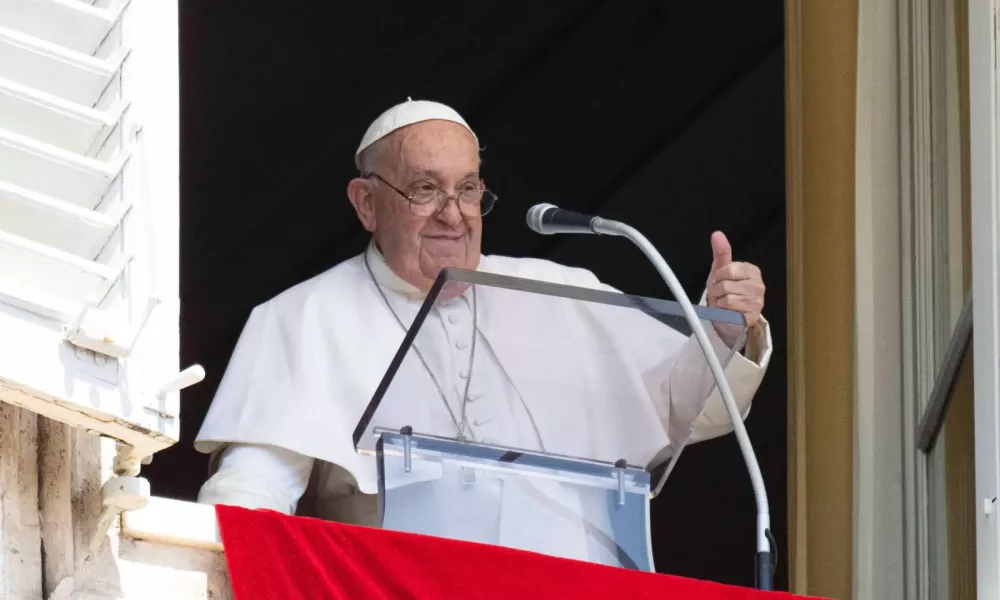 Pope Francis gives a thumbs-up to pilgrims at the Vatican during the Sunday Angelus