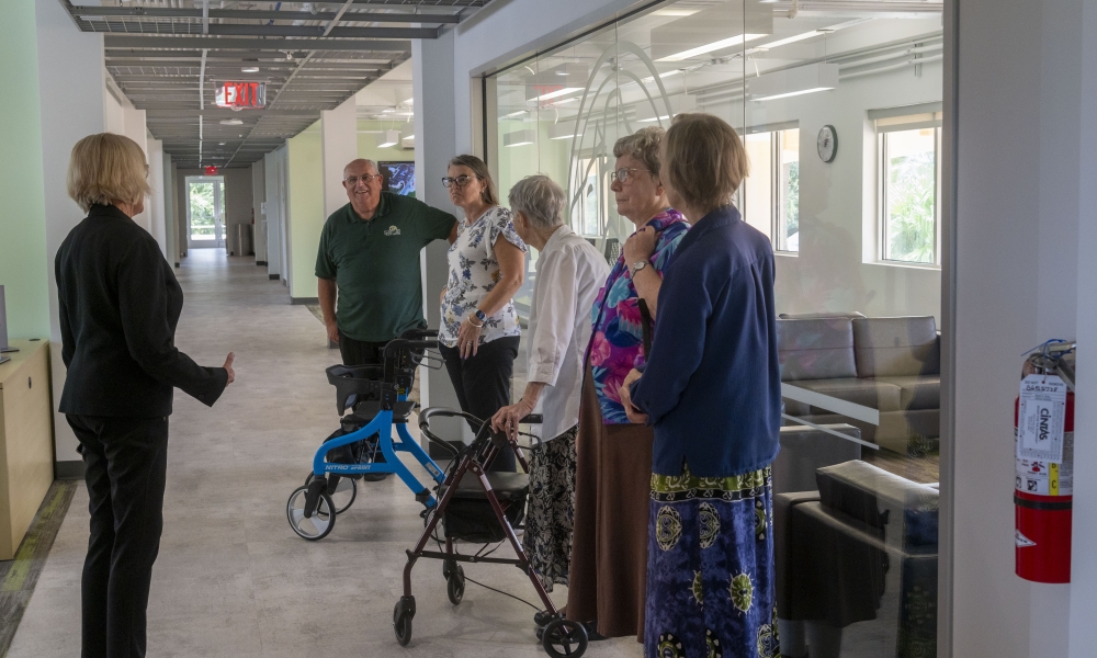 Dr. Kathleen Van Eerden, dean of the College of Health Professions, gives Sister Roberta Bailey, prioress of the Benedictine Sisters of Florida, and some of the sisters and volunteers, a tour of the new nursing floor in Benedictine Hall.| Photo by Marie Thornsberry, Saint Leo University.