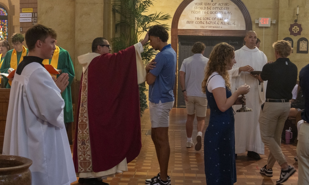Father Lucius Amarillas, OSB, blesses a student. | Photo by Caroline Jorgensen, Saint Leo University