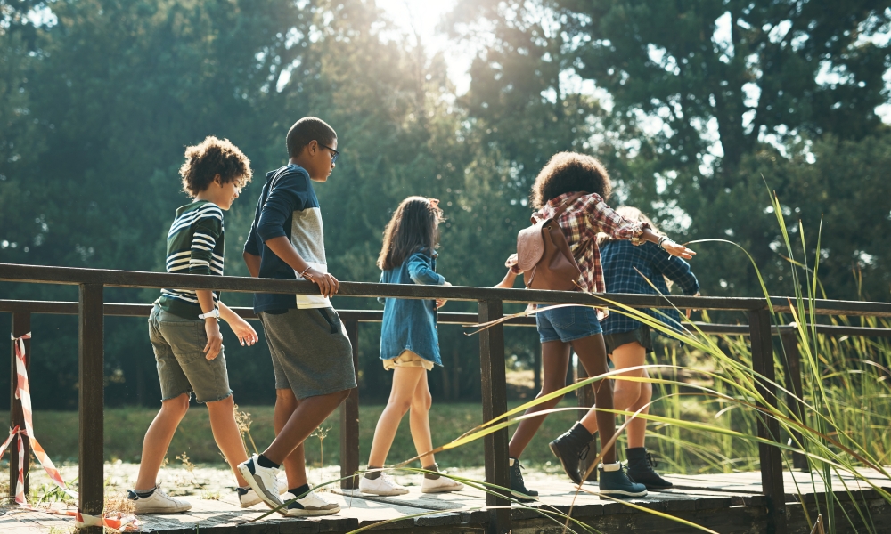 Kids walking on a bridge outside