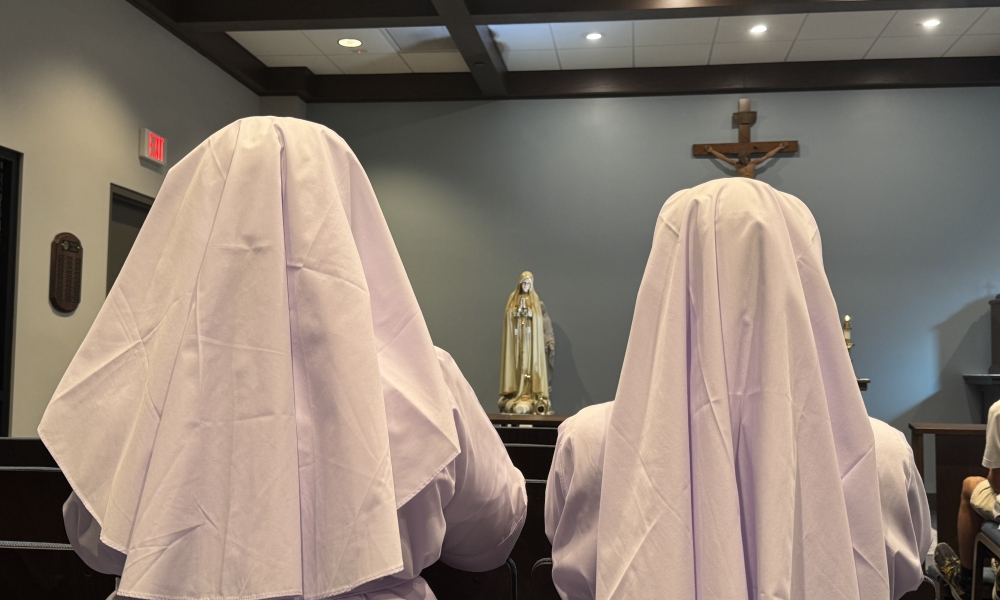 Sisters at Mass with statue