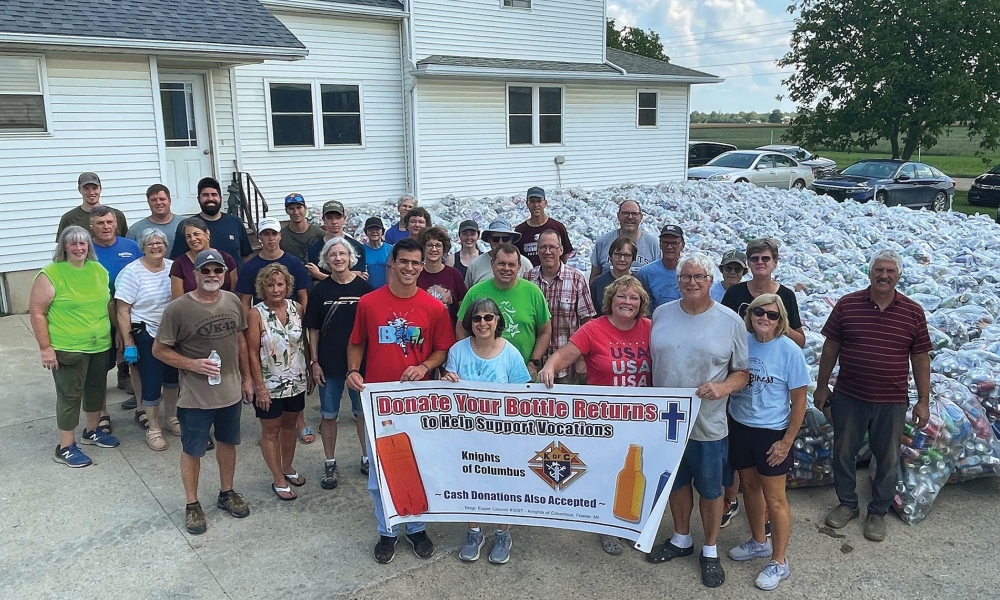 Knights and family members from Msgr. Esper Council 3027 in Fowler, Mich., gather near 131,000 bottles and cans collected during the council's annual Returns for Vocations fundraiser on June 13, 2024. The donated recyclables and additional cash contributions yielded $14,500 to support men and women in the Diocese of Lansing who are discerning the priesthood or religious life. (Photo credit: Knights of Columbus)