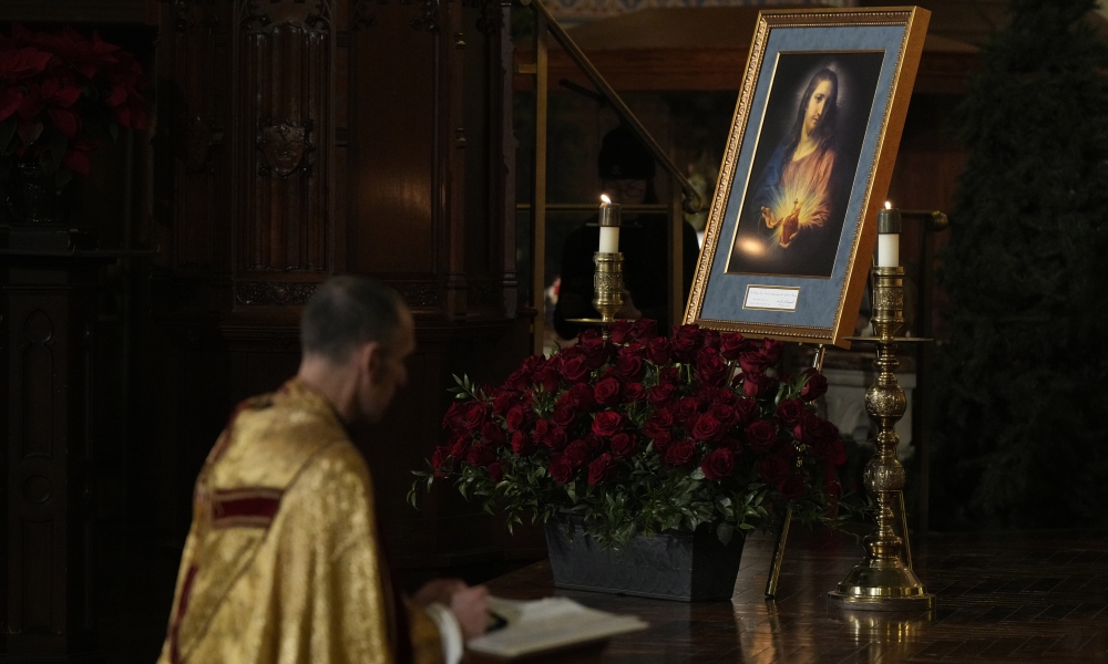 The new Knights of Columbus Sacred Heart Pilgrim Icon is seen as Father Ryan Lerner prays during a Sacred Heart Holy Hour at St. Mary's Church in New Haven, Connecticut, Jan. 3, 2025. (Photo by Paul Haring)