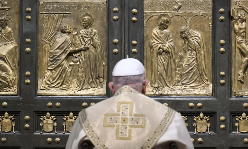 Pope Francis opens the Holy Door of St. Peter’s Basilica before Mass on Christmas Eve, Dec. 24, 2024, officially launching the Jubilee Year 2025. | Photo by Vatican Media