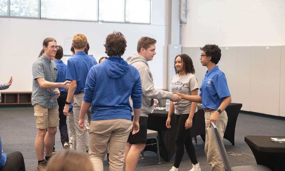 Members of the Jesuit High School and Academy at the Lakes 2024 Brain Bowl teams shake hands