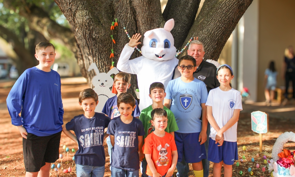 Children take a photo with John Morris at the Easter Baskets of p-LENT-y drive.