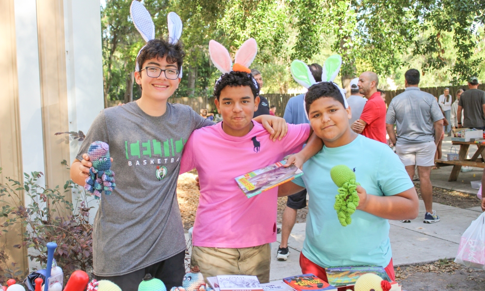 Young people pose for a photo with Easter eggs at the Easter Baskets of p-LENT-y drive.