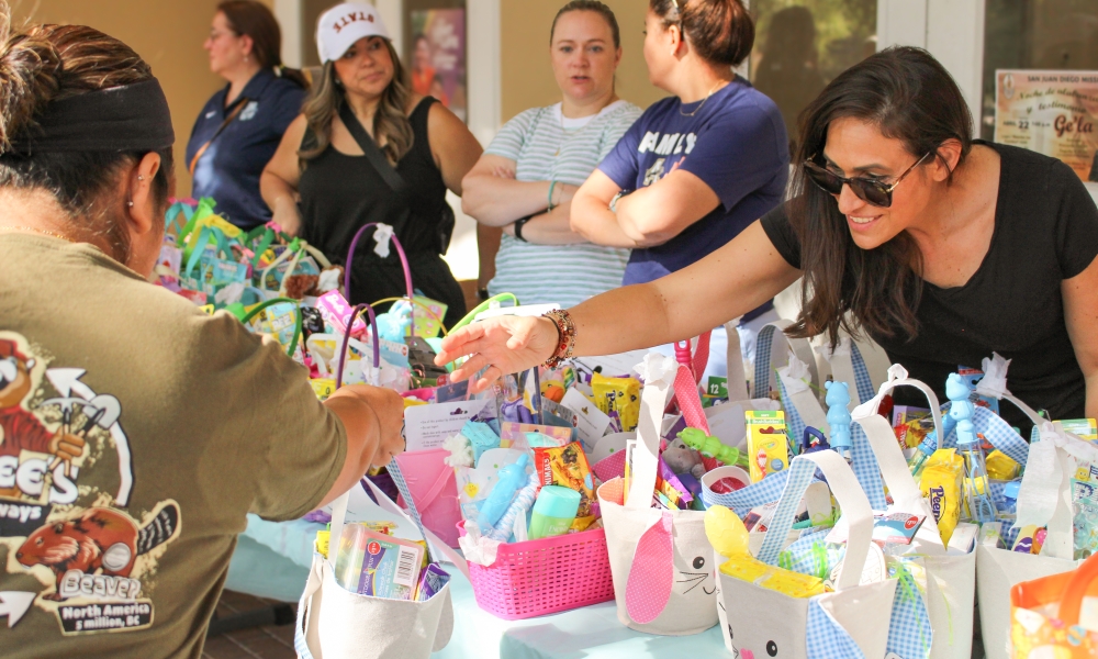 Volunteers distribute baskets to families at the Easter Baskets of p-LENT-y drive.