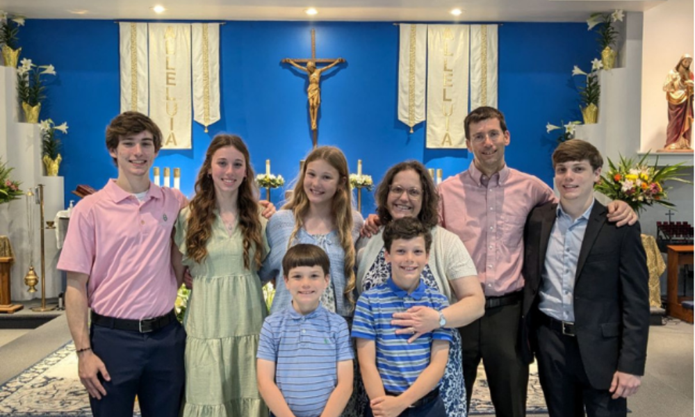 Alumni Teresa and Brian Werthmiller with their children in St. Luke's Chapel at the Catholic Student Center. | Courtesy Photo.