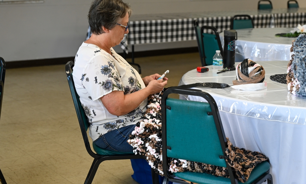 Connie works on crocheting a mat. | Photo by Brittany DeHaan.