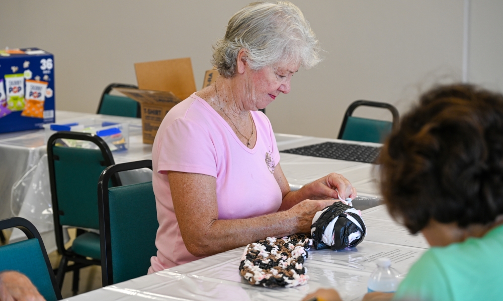 Volunteers work on making the mats for the homeless. | Photo by Brittany DeHaan.