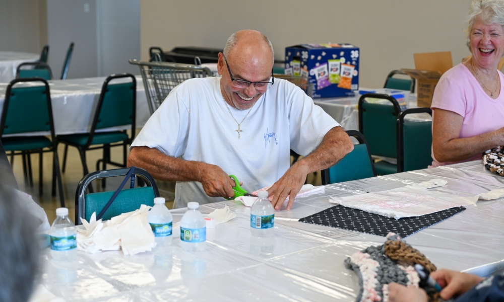 Volunteers work on making the mats for the homeless. | Photo by Brittany DeHaan.