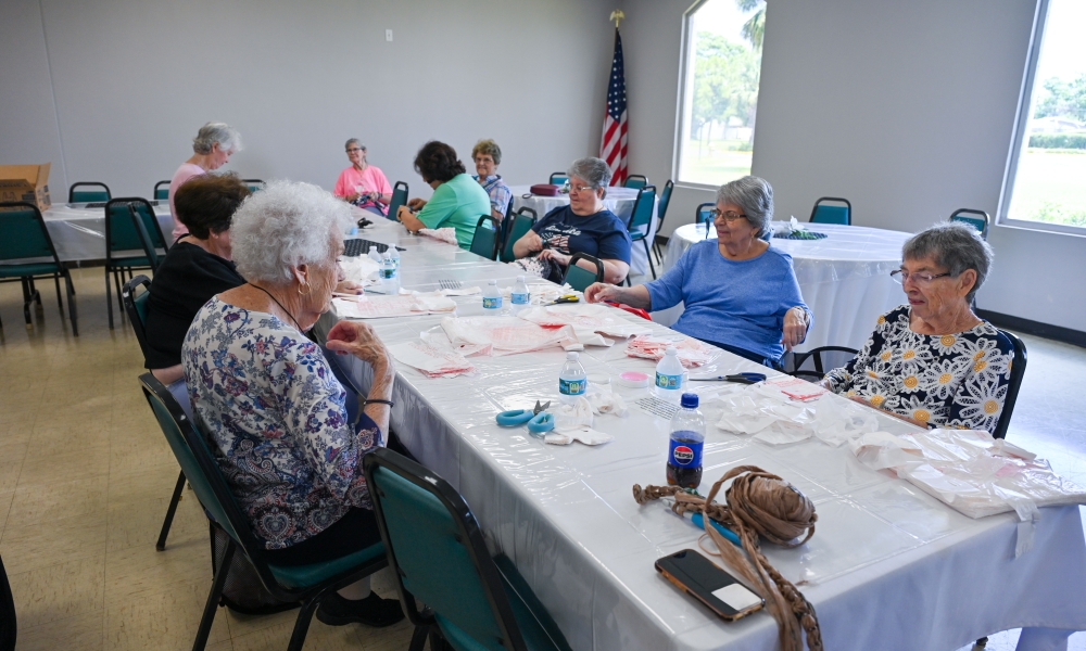 Volunteers work on making the mats for the homeless. | Photo by Brittany DeHaan.