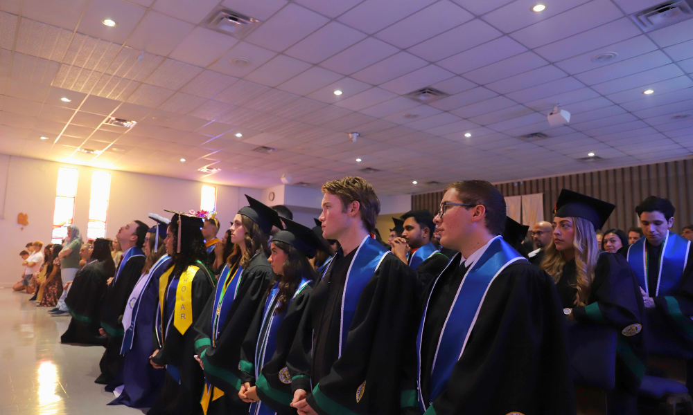 Graduates kneel during the consecration at the Baccalaureate Mass. | Courtesy photo.