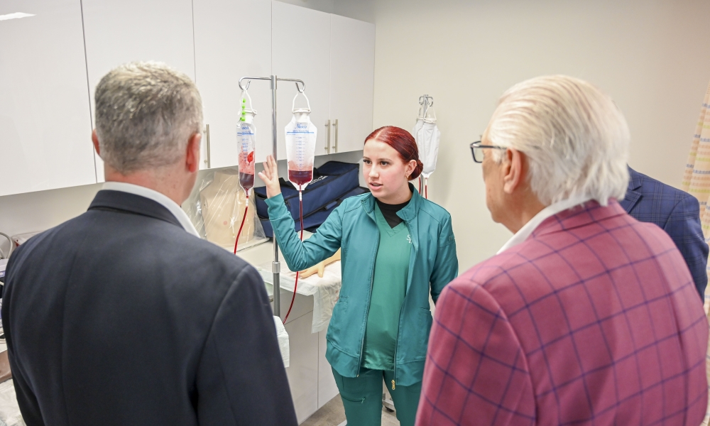 At the February 2025 grand opening of Saint Leo University’s nursing floor, student Samantha Chapman explains the IV lab during a tour.