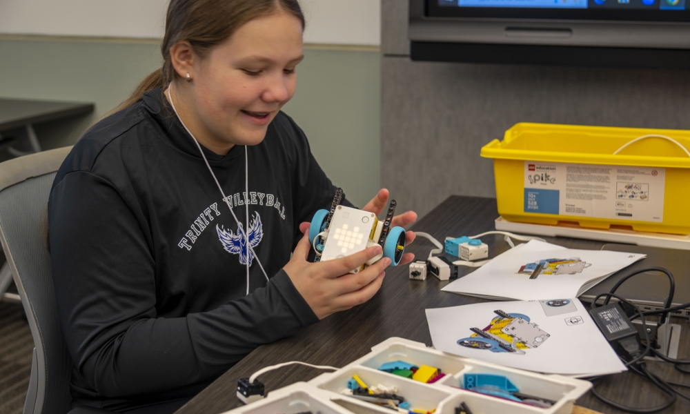 Sophia Ustymenko builds a SPIKE Prime robot at Saint Leo University on May 4 | Photo by Caroline Jorgensen, Saint Leo University.