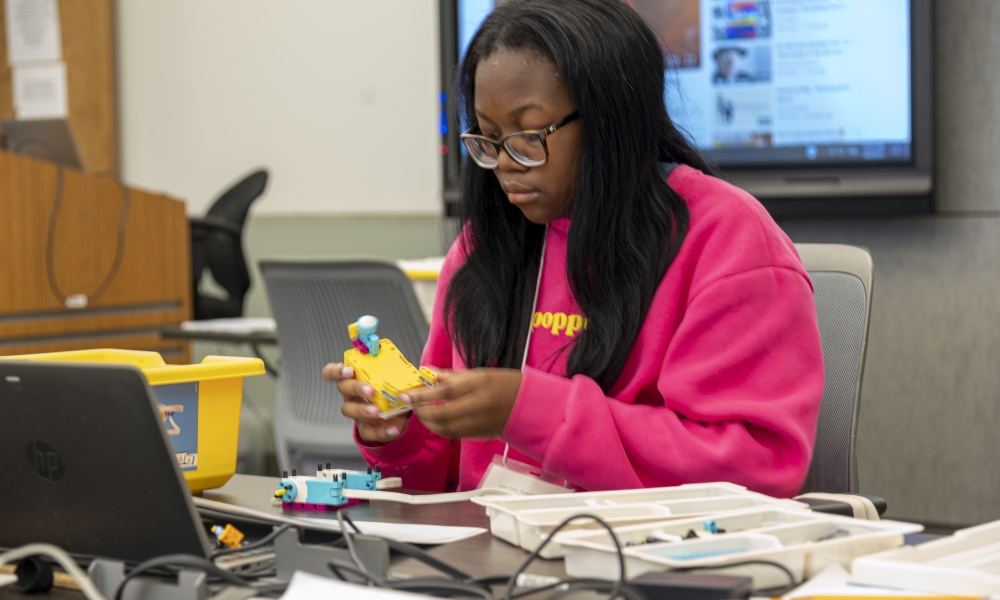 Voke Koyonda works on her robot during Girls Can! Robotics Camp 2025.