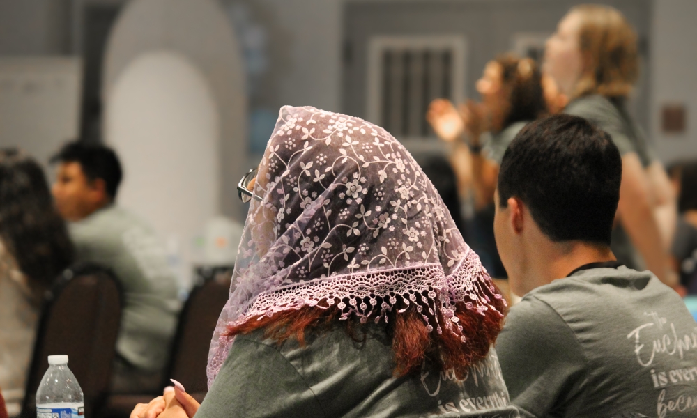 Andrea Suarez prays during Praise and Worship.