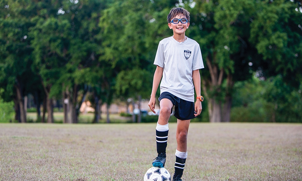 Boy posing with a soccer ball
