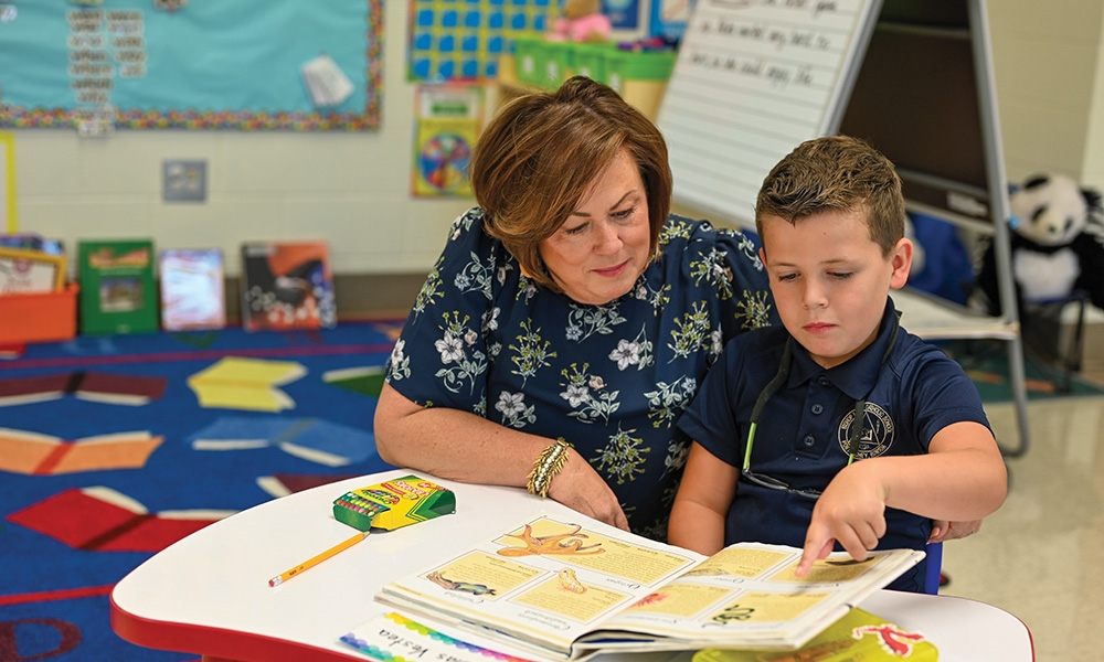 Principal Stacy Cervone works with Nikolas