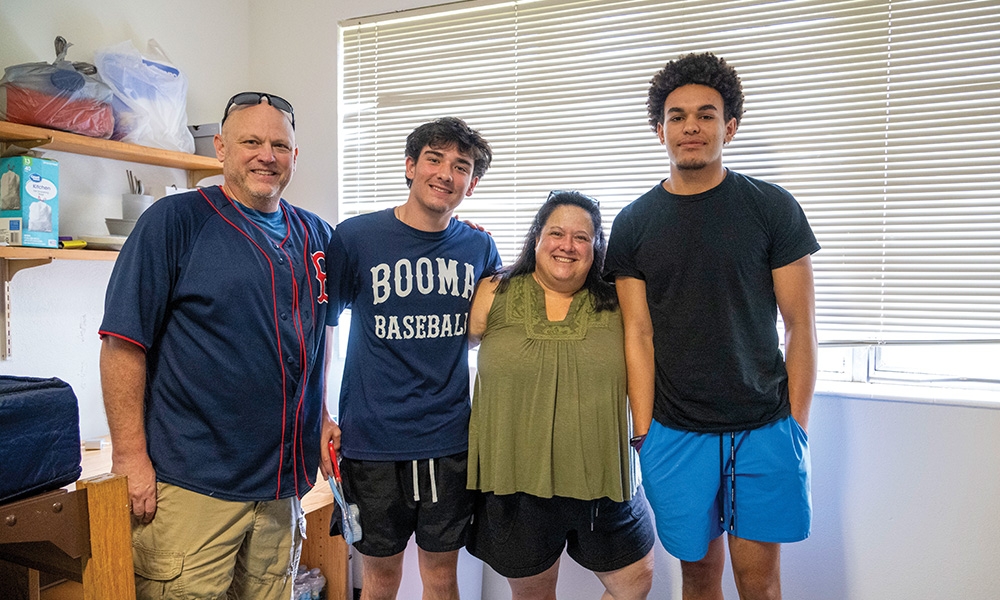 A Saint Leo University student and his family photographed during campus housing move-in day.