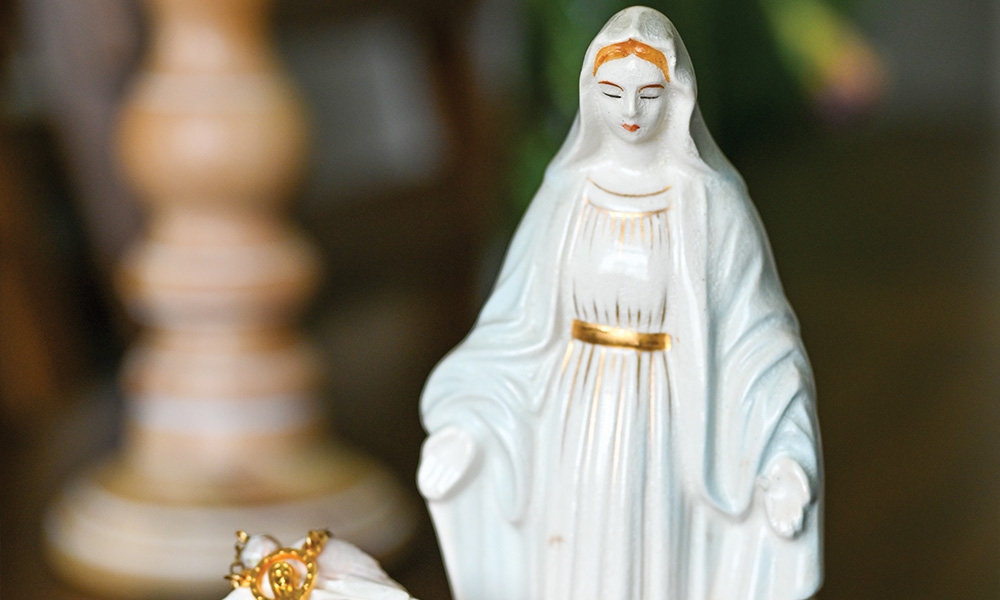 Small statue of the Blessed Virgin with a rosary