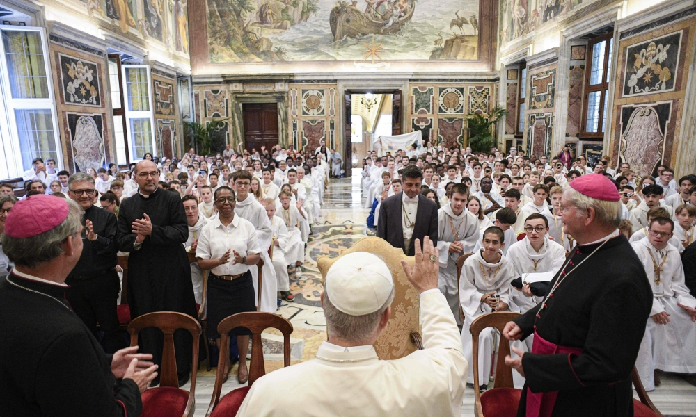 Pope Leo XIV greets French altar servers during an audience on Aug. 25, 2025, at the Vatican.