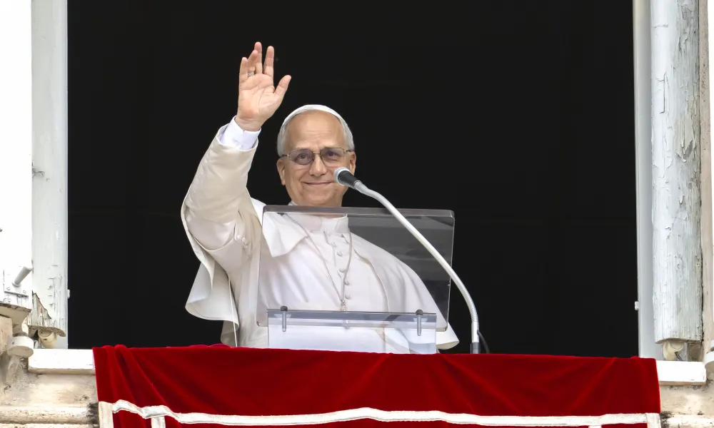 Pope Leo XIV waves to the crowd during his Angelus address on Aug. 24, 2025.