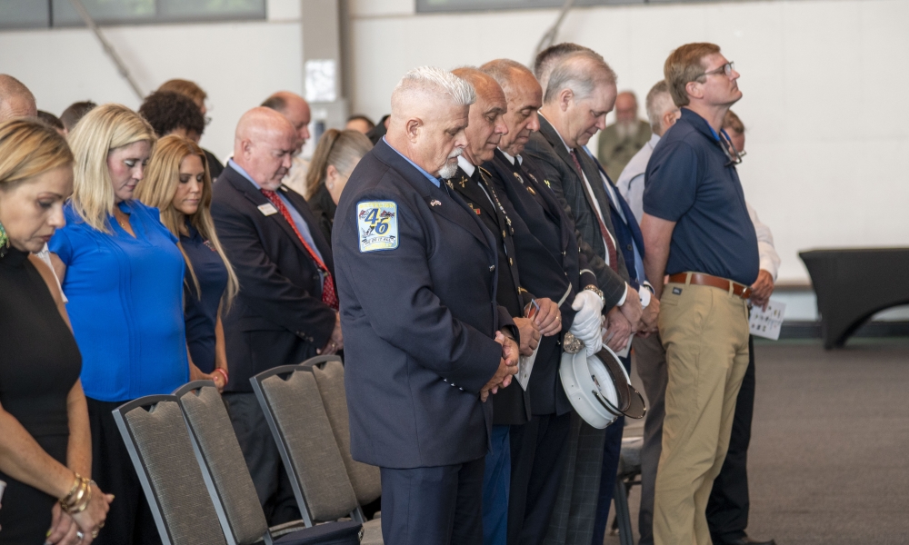 Stephen Spelman, Dominick Maggiori, Perry Blackburn, Wilton Simpson, Seth Weightman, Craig Gross, Bob Hatfield and other honored guests bow their heads during prayer.