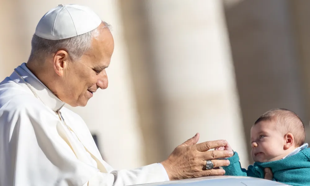 Pope Leo XIV greets a baby at his general audience in St. Peter's Square at the Vatican, Wednesday, Oct. 8, 2025. Credit: Daniel Ibáñez/CNA