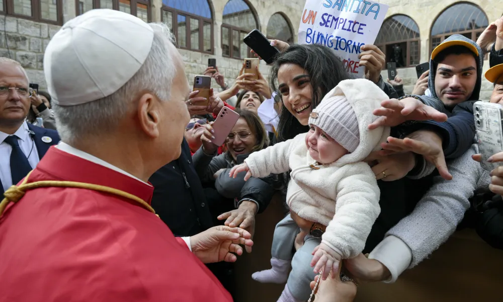 Pope Leo XIV greets a young mother and her child outside of the Monastery of St. Maron in Annaya, Lebanon, on Dec. 1, 2025. | Photo by Vatican Media.