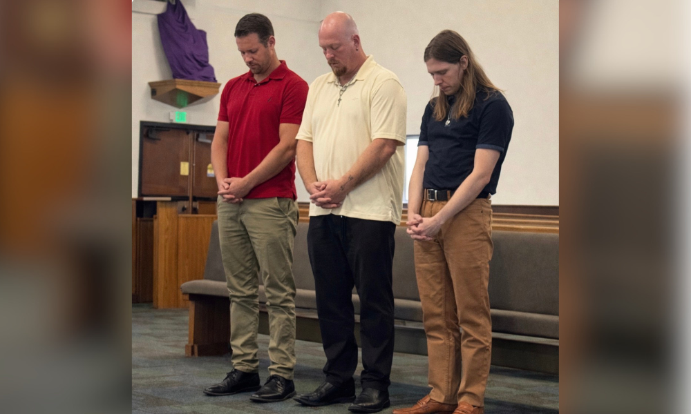 The trio prays at St. Patrick Catholic Church in Largo. | Courtesy Photo.